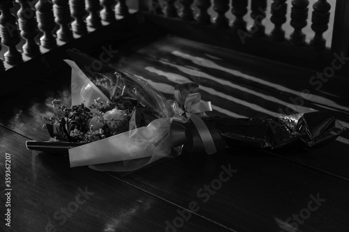 Dried beautiful flower bouquet on a wooden table in memory ,monochrome