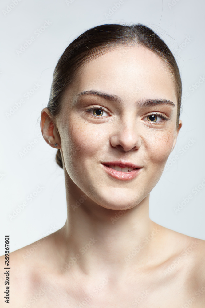 Emotional young woman face portrait with cheerful facial expression. Human female natural emotions and expressions concept. Girl with clean, healthy skin and nude makeup posing on white background. Emotional young woman face portrait with cheerful facial expression. Human female natural emotions and expressions concept. Girl with clean, healthy skin and nude makeup posing on white background.