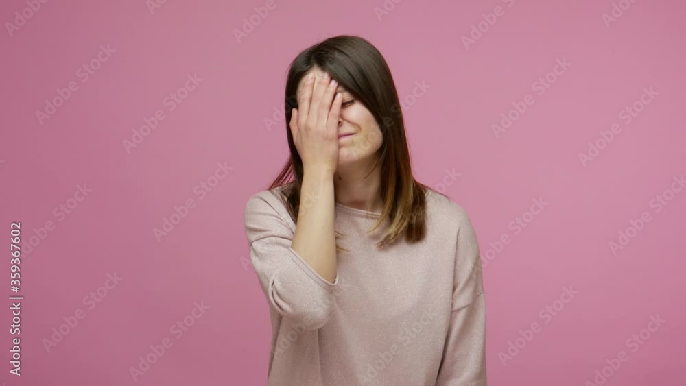 Facepalm, sorrow emotions. Upset worried brunette woman slapping hand on face and expressing regret, blaming herself for troubles, feeling helpless. indoor studio shot isolated on pink background Facepalm, sorrow emotions. Upset worried brunette woman slapping hand on face and expressing regret, blaming herself for troubles, feeling helpless. indoor studio shot isolated on pink background
