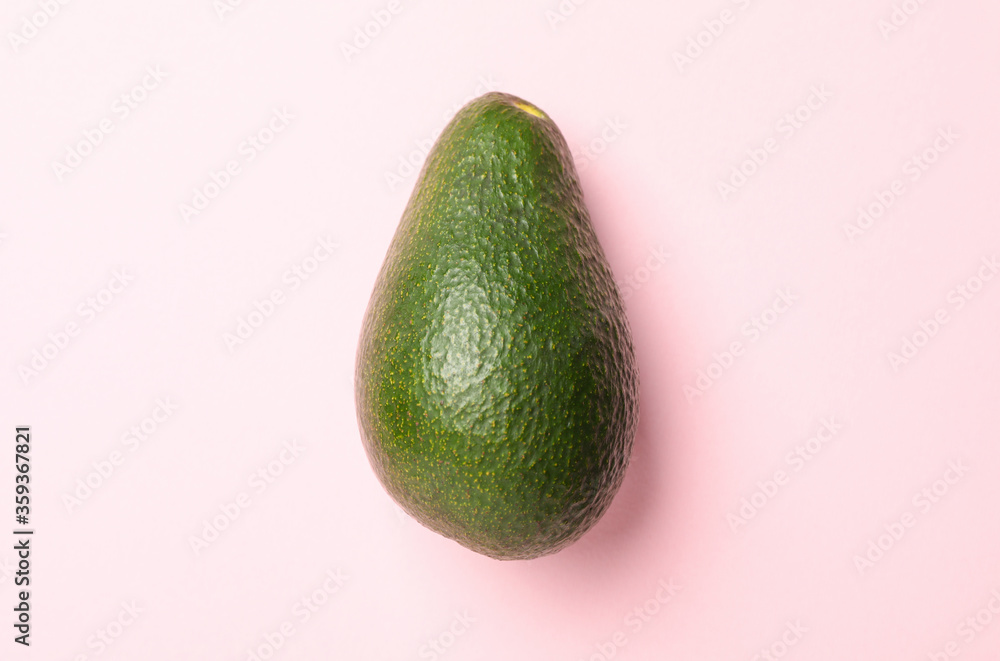 Ripe fresh avocado on pink background, close up Ripe fresh avocado on pink background, close up