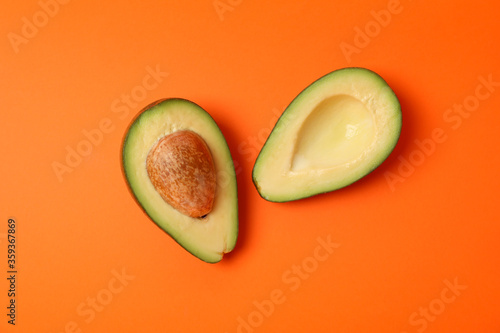 Ripe fresh avocado on orange background, top view