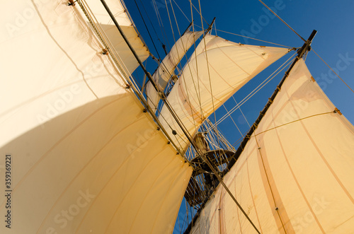 Tall ship sails in sunny day