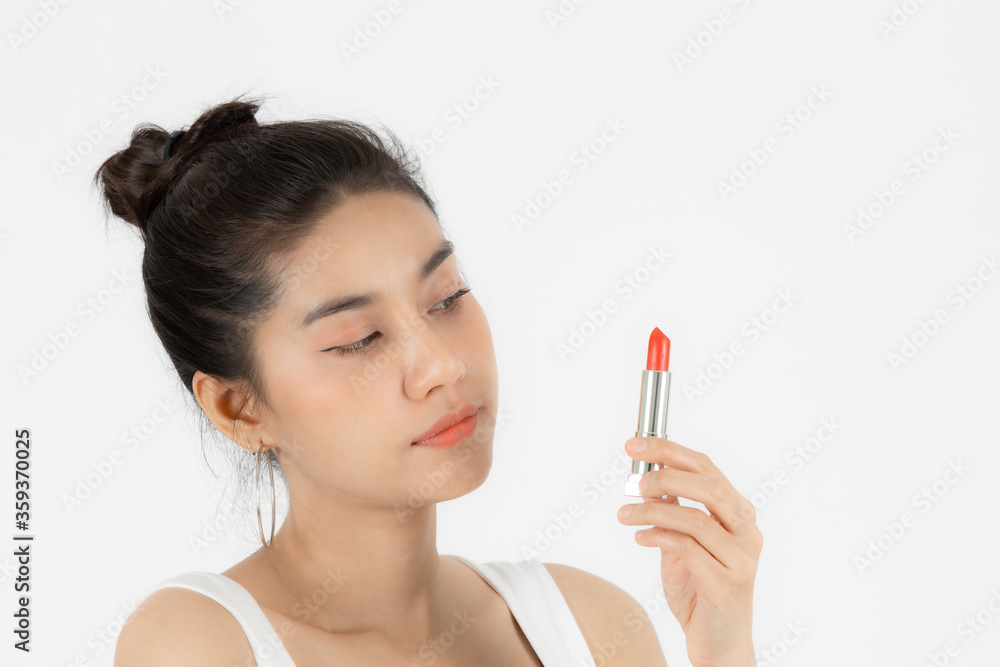 Healthy and cosmetics concept. Beauty face of young Asian woman applying make up with lipstick over white isolated background. Healthy and cosmetics concept. Beauty face of young Asian woman applying make up with lipstick over white isolated background.