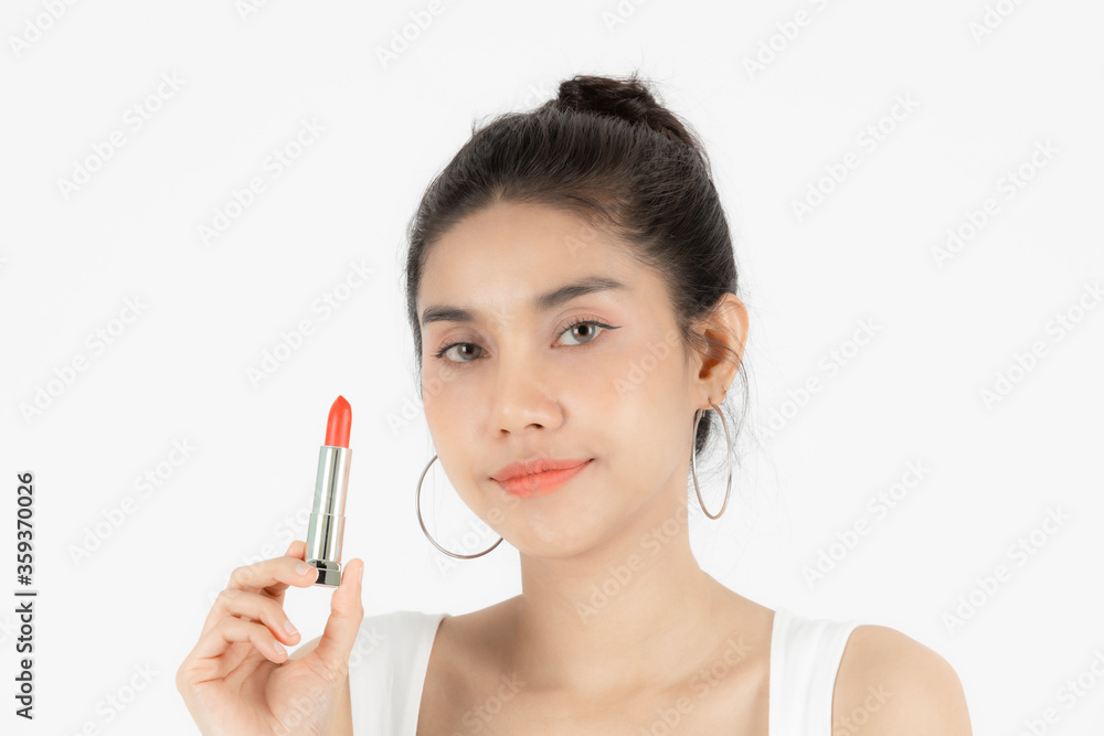 Healthy and cosmetics concept. Beauty face of young Asian woman applying make up with lipstick over white isolated background.