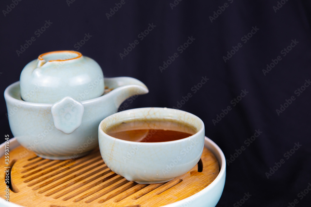 A set of Chinese traditional pottery teapot and cups, serving black tea. A set of Chinese traditional pottery teapot and cups, serving black tea.