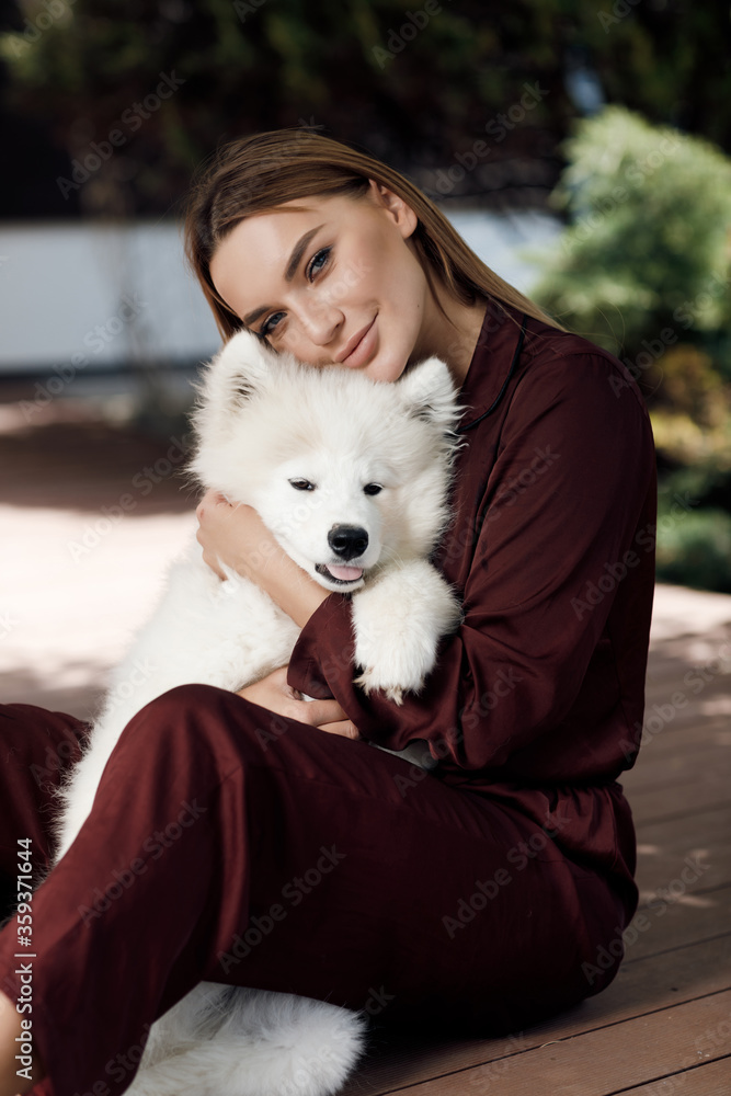 Young smiling woman sitting with dog outdoor Young smiling woman sitting with dog outdoor