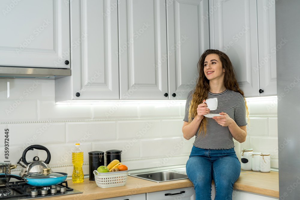 Gorgeous woman relax morning in kitchen and drinking enjoy coffee Gorgeous woman relax morning in kitchen and drinking enjoy coffee