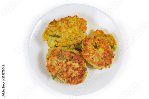 Savory rice fritters with vegetables on dish, top view