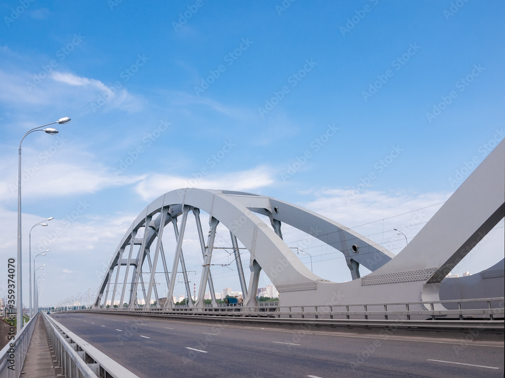 Obraz premium Part of road and railroad bridge with steel arches