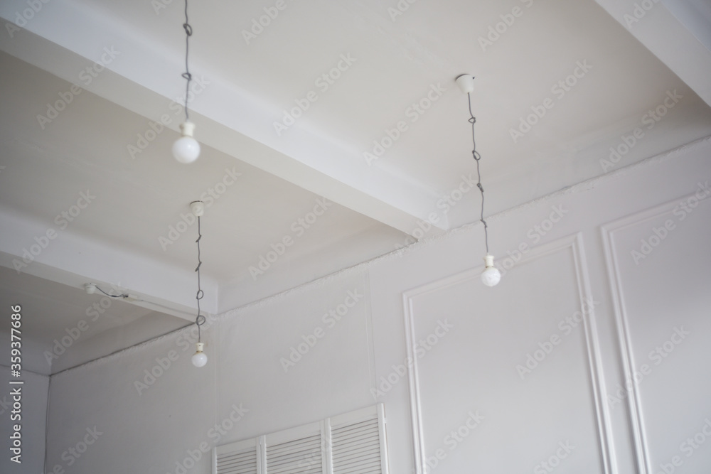 Lamps hang directly from the ceiling with laces and cables. Loft style interior Lamps hang directly from the ceiling with laces and cables. Loft style interior