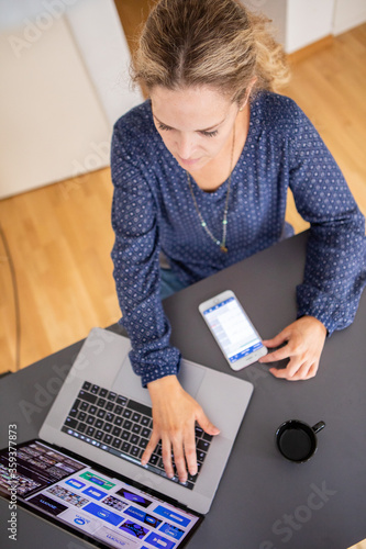 business woman working on a desk with laptop and phone. 