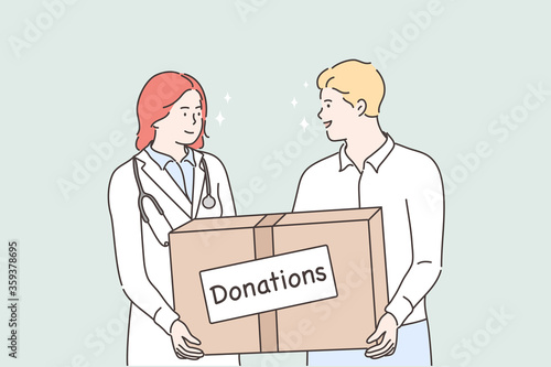 Medicine, help support, donation concept. Young man and woman doctor holding huge bog with donations medical face masks and treatment from viruses deseases. Humanitarian support or goodwill mission.