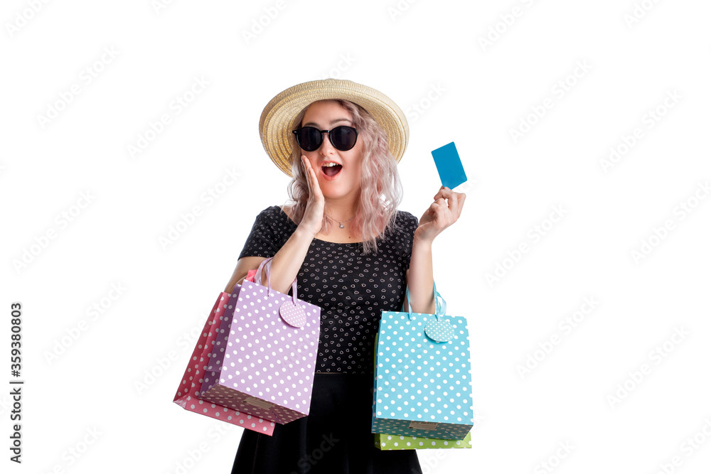 A girl in a black blouse with colorful bags in her hands and a credit card after shopping A girl in a black blouse with colorful bags in her hands and a credit card after shopping