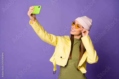 Portrait of her she nice-looking attractive lovely pretty fashionable cheerful cheery girl taking making selfie isolated over bright vivid shine vibrant lilac purple violet color background