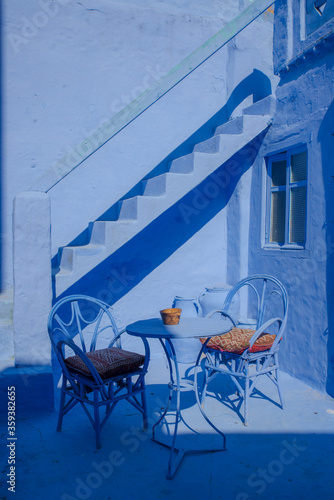 Beautiful house in chefchouen, the city known for his colorful streets and walls. Blue door, entrance of cozy house. photo