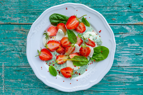 A healthy and delicious salad made from fresh strawberries and mozzarella.