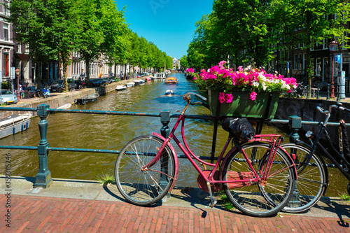 Amsterdam canal with boats and bicycles on a bridge © Dmitry Rukhlenko