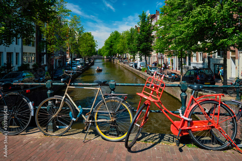 Amsterdam canal with boats and bicycles on a bridge