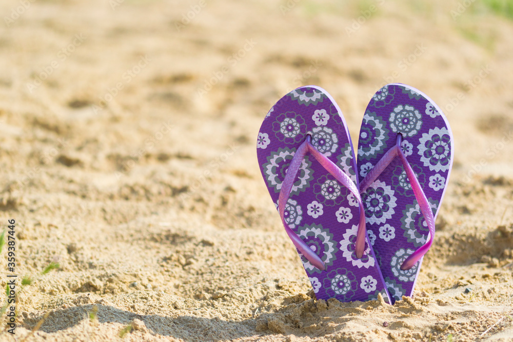 Fototapeta premium Purple sandals on the beach.