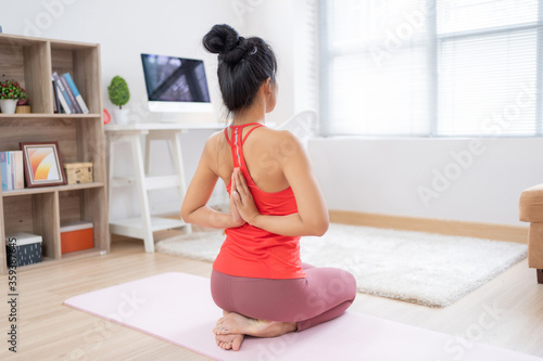 Asian woman exercising at home she is doing yoga