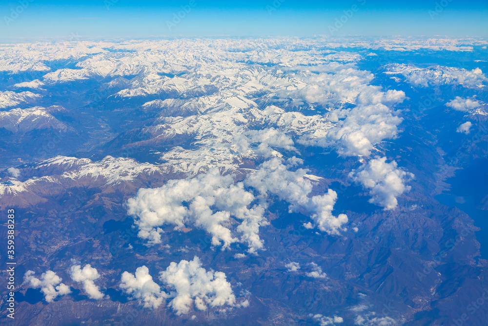 Naklejka premium clouds and snowy mountains panorama