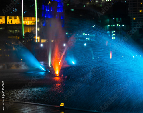 red and blue of fountain in night city lights