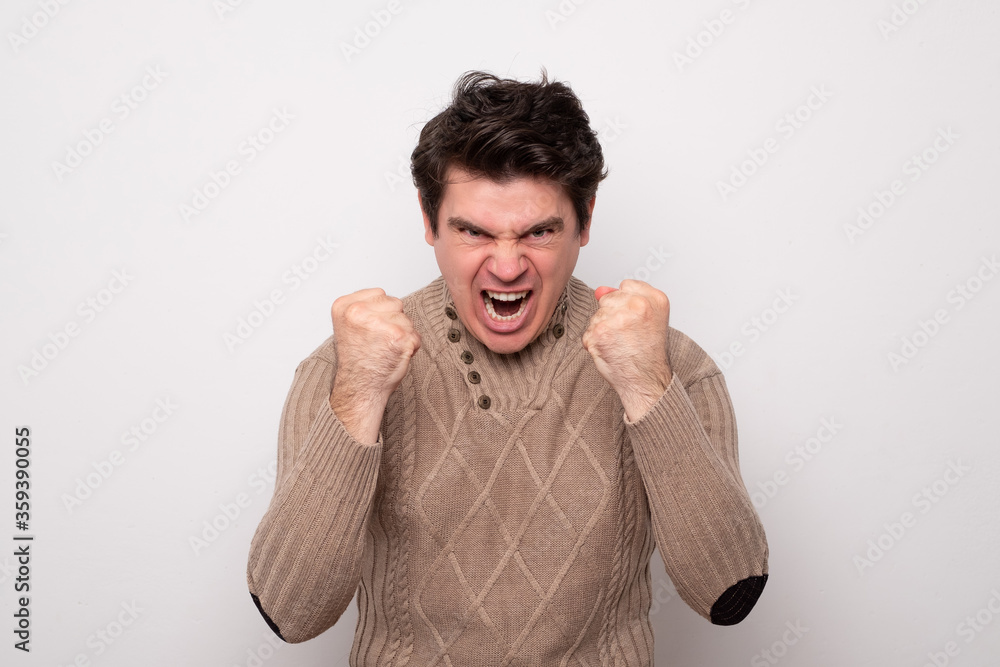 Screaming man in a warm sweater. Angry man. Screaming man in a warm sweater. Angry man.