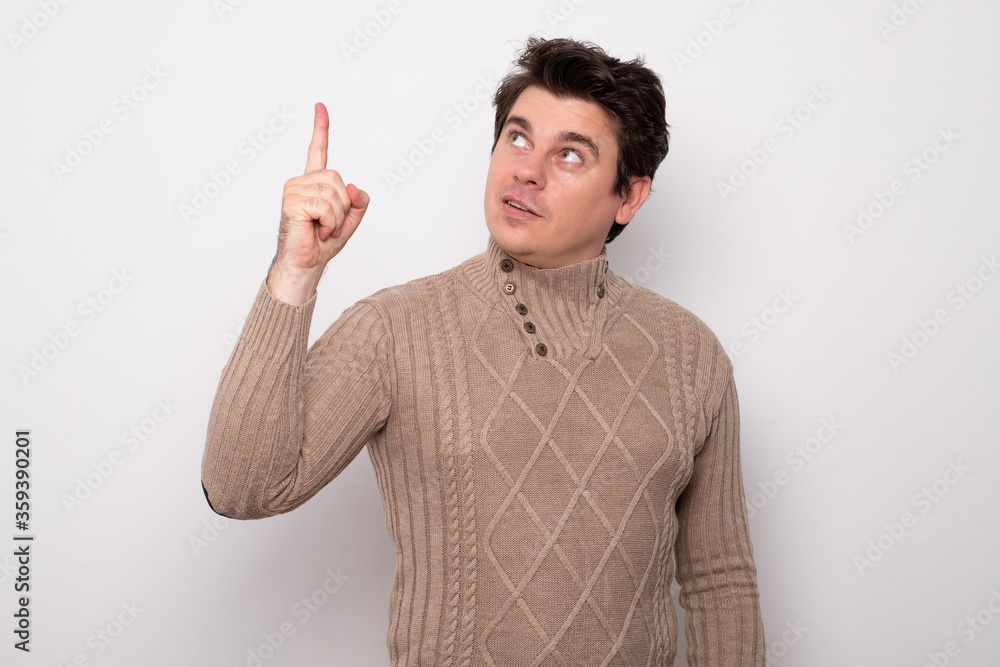 Handsome man pointing at empty space. Handsome man pointing at empty space.