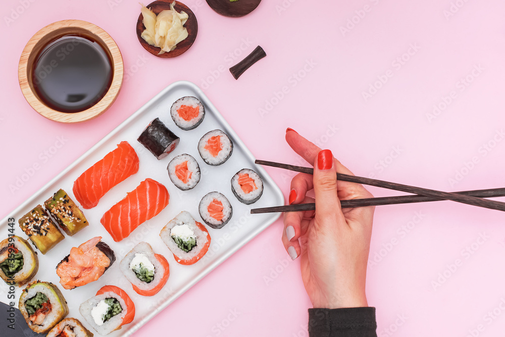 Sushi set with salmon on pink background, top view. Sushi set with salmon on pink background, top view.