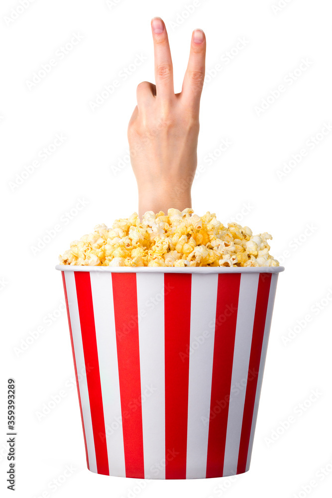 Female hand sticks out of a bucket with popcorn isolated on white background Female hand sticks out of a bucket with popcorn isolated on white background