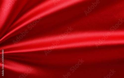 Red silk fabric texture . Beautiful soft crumpled silk xmas, festive background.Copy space