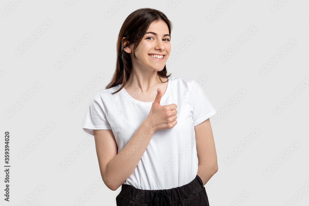 Like gesture. Perfect choice. Happy woman showing thumb up isolated on neutral background. Like gesture. Perfect choice. Happy woman showing thumb up isolated on neutral background.