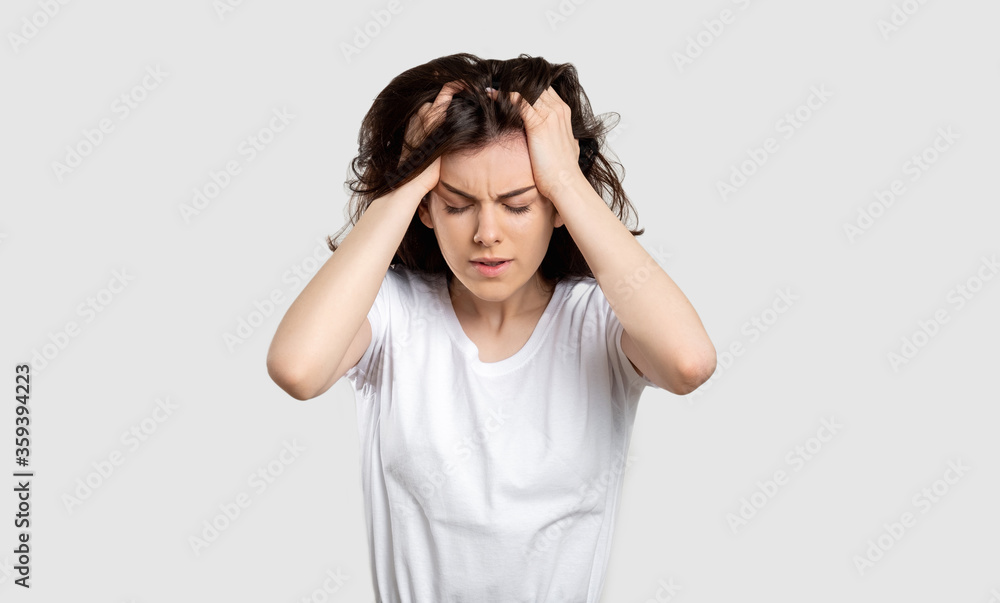 Frustrated woman portrait. Mental disorder. Lady with strong headache isolated on light background. Frustrated woman portrait. Mental disorder. Lady with strong headache isolated on light background.