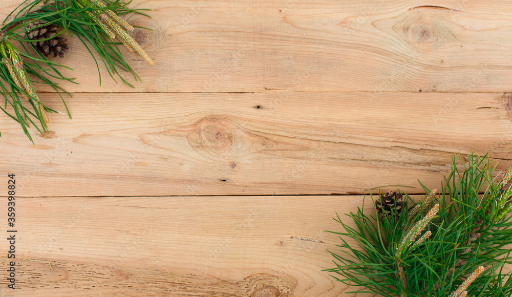 Christmas flatlay on a rustic wooden background: green pine needles with cones. New year's concept, winter holiday home comfort. Natural style, eco-friendly lifestyle. Space for text, mock up Christmas flatlay on a rustic wooden background: green pine needles with cones. New year's concept, winter holiday home comfort. Natural style, eco-friendly lifestyle. Space for text, mock up