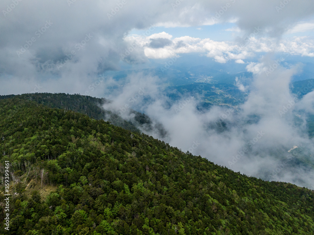 新緑の恵那山山頂上空よりガス立ち昇る中津川方面を空撮