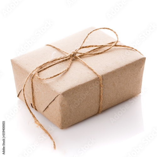 Gift box wrapped with white paper and burlap ribbon isolated on white background.