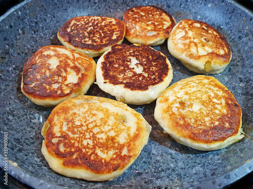 fresh cheesecakes fried in a pan, curd pancakes