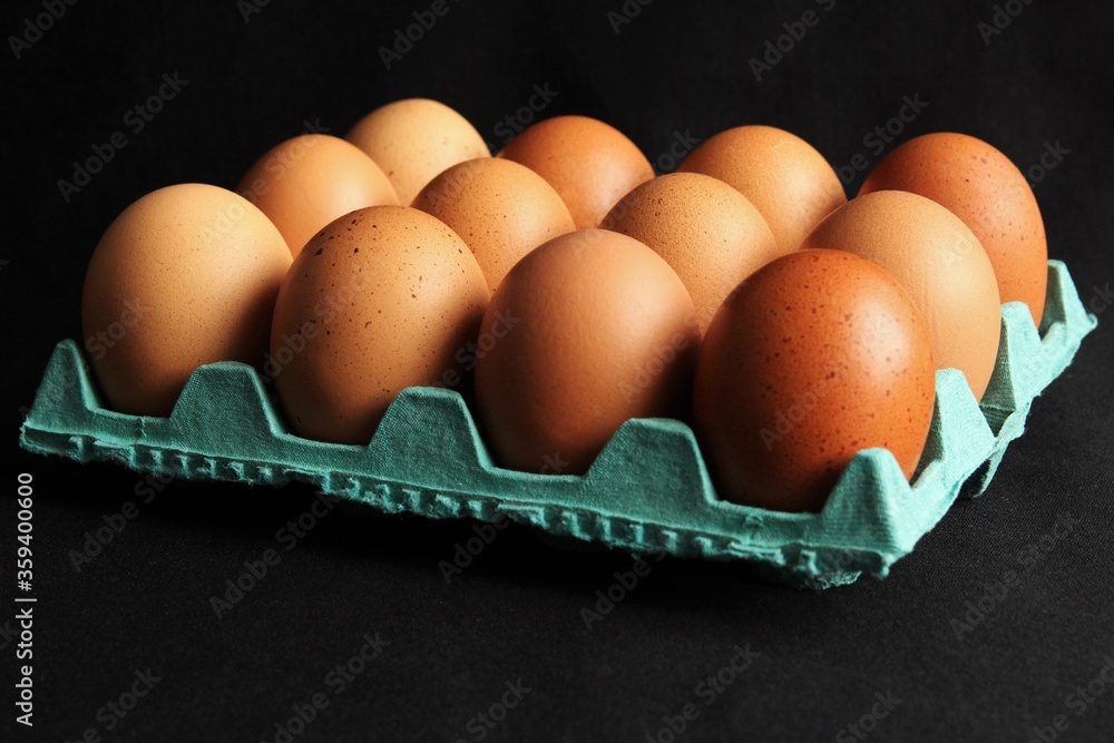 Dozen of eggs in green carton. photo Dozen of eggs in green carton. photo