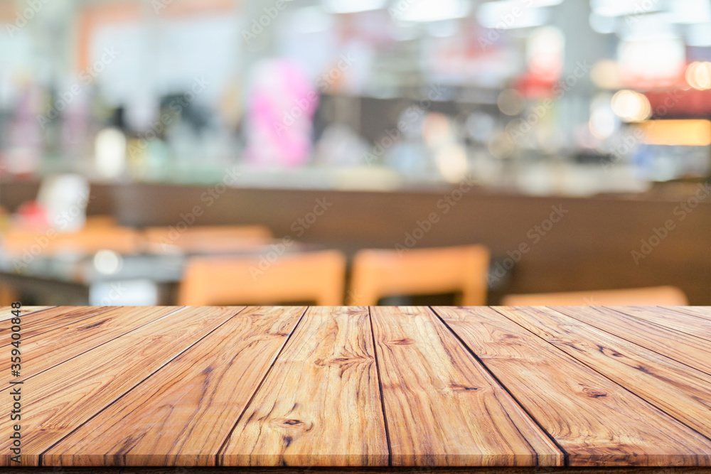 Wooden table top on blurred background of interior coffee shop or restaurant blur cafe coffee shop background Wooden table top on blurred background of interior coffee shop or restaurant blur cafe coffee shop background