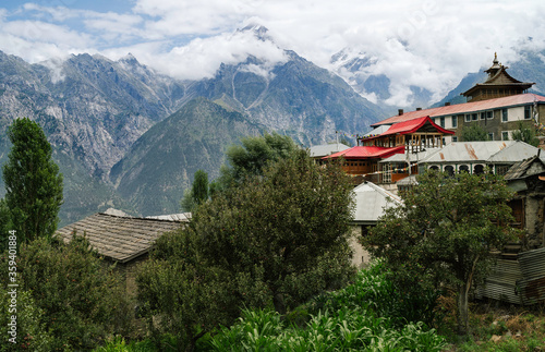 Kalpa village with apple trees, houses, and Himalayas. Himachal Pradesh, India.