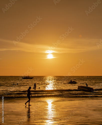 silhouette of a sunset ray on the beach