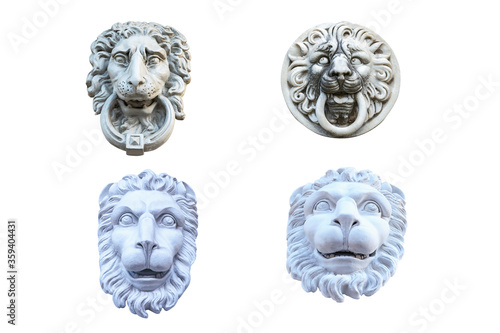 four plaster sculptures of lion heads to decorate the facade of the building isolated on a white background