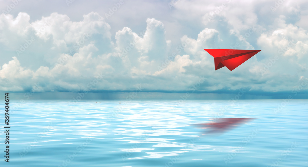 Red paperplane in the beautiful seascape with cloud on a sunny day. Red paperplane in the beautiful seascape with cloud on a sunny day.