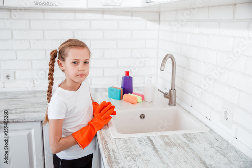 Chores for children . Girl is going to wash dishes