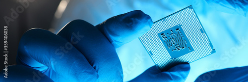 Fotografija Close-up gloved hands holding detail microchip