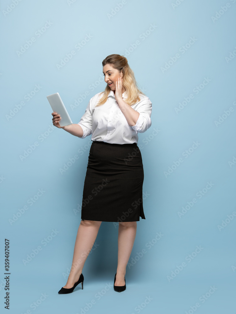 Wondered. Young woman in office attire. Bodypositive female character, feminism, loving herself, beauty concept. Plus size businesswoman on blue background. Boss, beautiful. Inclusion, diversity. Wondered. Young woman in office attire. Bodypositive female character, feminism, loving herself, beauty concept. Plus size businesswoman on blue background. Boss, beautiful. Inclusion, diversity.