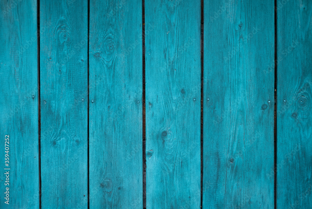 The wall of the house is made of old wood. Wooden details in the form of a lines. Background and texture of old painted wood. The wall of the house is made of old wood. Wooden details in the form of a lines. Background and texture of old painted wood.