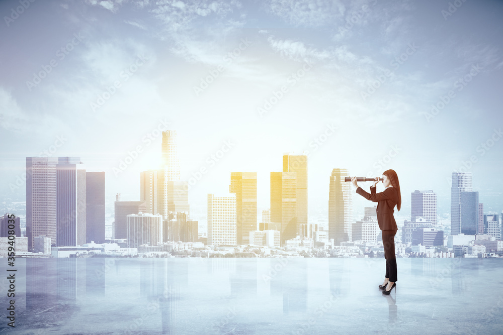 Young businesswoman using binoculars Young businesswoman using binoculars