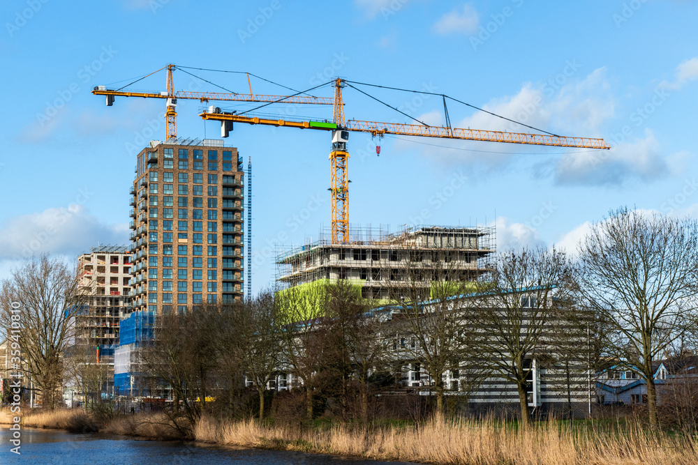 Fototapeta premium Large housing construction project with large cranes in Amersfoort, Netherlands 