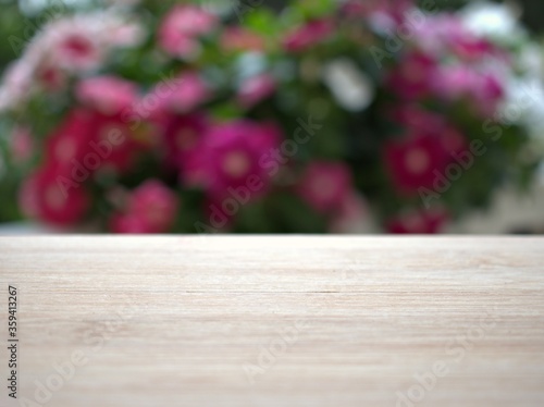 Empty wood table top on blur flowers in garden background ,nature abstract blurred, display product, balnk table  © Suganya